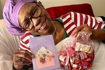 Image of elderly lady having received many mother,s day gifts