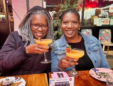 two ladies drinking a cocktail